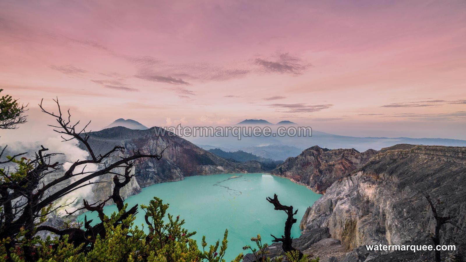A landscape photo of a crater lake at sunset, watermarked with watermarquee.com
