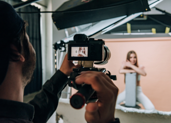 Male photographer focusing on a female model's face
