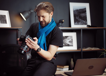 Handsome photographer looking at a camera