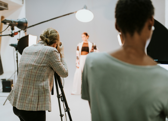 Female photographers taking photos of an aspiring model