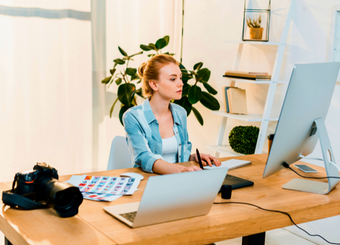 Beautiful photographer working on a computer