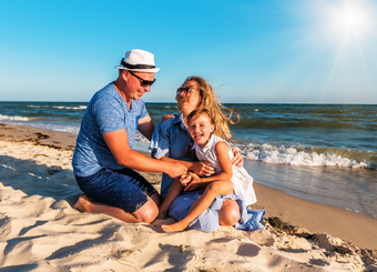 A happy family sitting in the beach