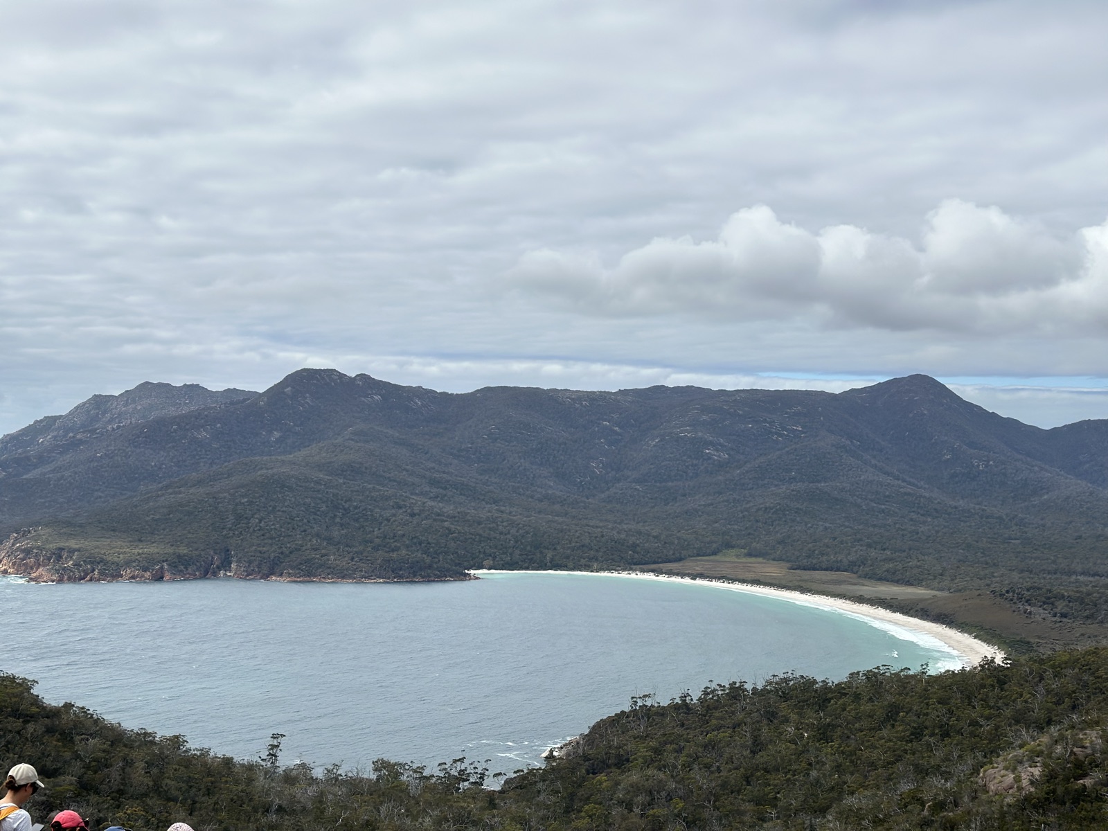 The curved white sand and turquoise water of Wineglass Bay seen from the lookout in Freycinet National Park, Tasmania