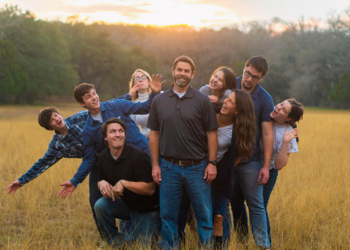 photo of a family doing weird poses on a field