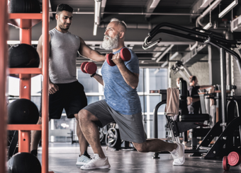 Trainer and a man doing exercise with barbells